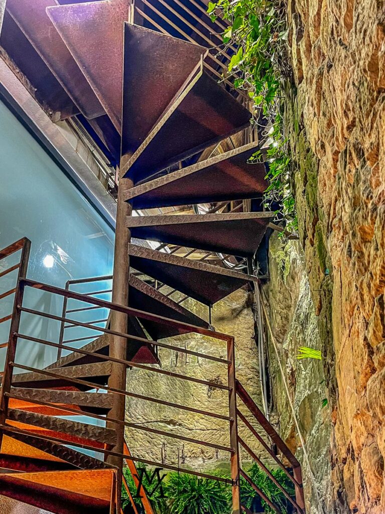 View on staircase with ancient-style brick walling in house for sale in Rollingergrund Luxembourg