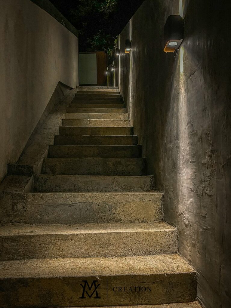 Night view of outdoor staircase and lighting on beautiful brick wall of house for sale in Rollingergrund Luxembourg